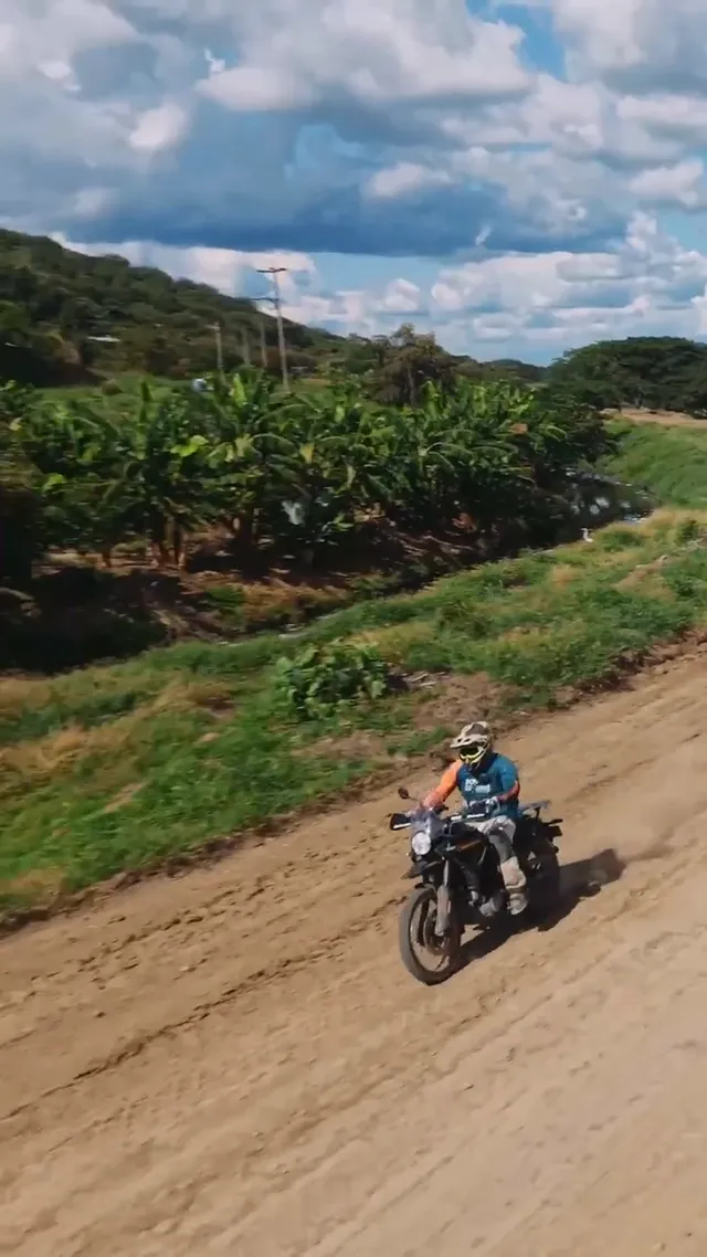 A rider on a dirt road through the plantations