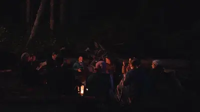 Guests around the campfire after dark