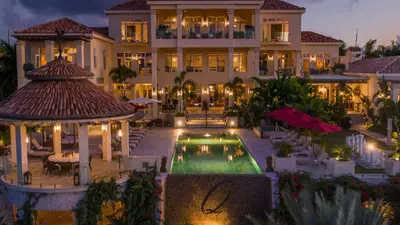 Quintessence Hotel, Anguilla, lit at dusk above its infinity pool