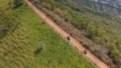 Riders on a track through the fields, from the air