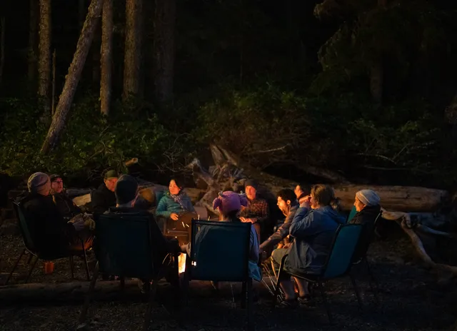 Guests gathered around the campfire after dark