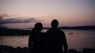 Two guests watching the last light over the strait