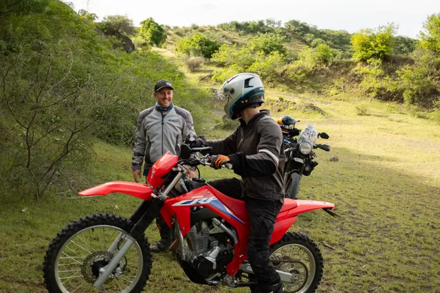 A guide coaching a rider on the off-road course at Donkey Sunrise