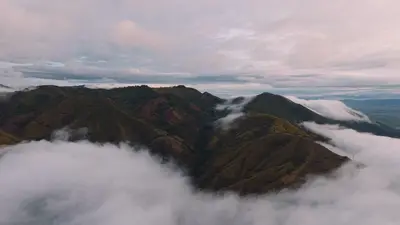 Cloud spilling over the ridges at dawn