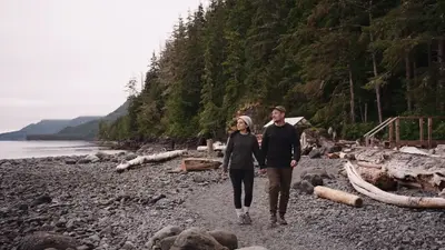 A couple walking the beach below the camp