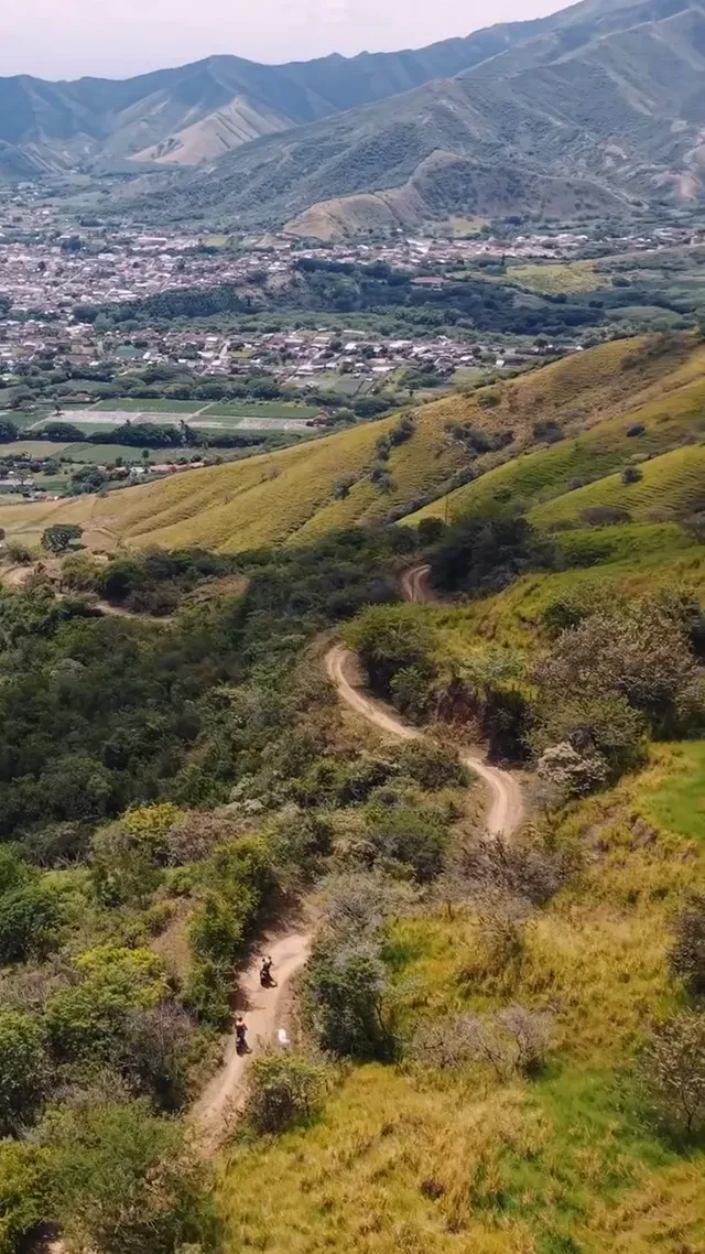 Switchbacks cut into the hillside above the valley