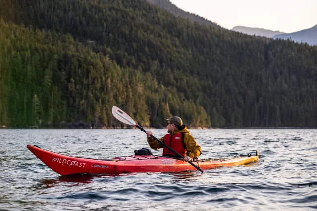 Sea kayaker paddling the shoreline of Johnstone Strait