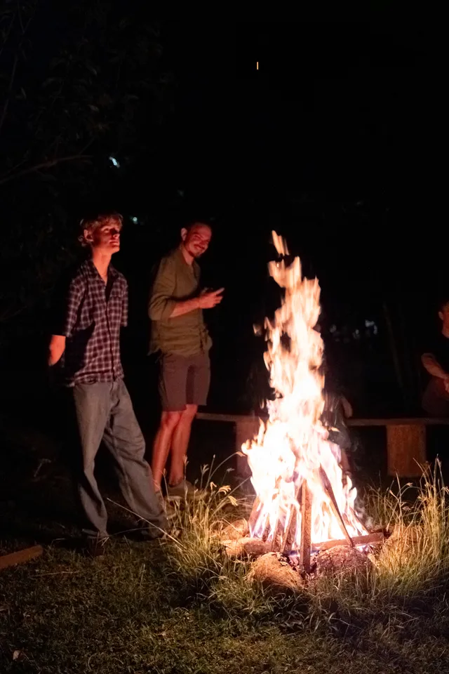 Guests around the bonfire at Donkey Sunrise after dark