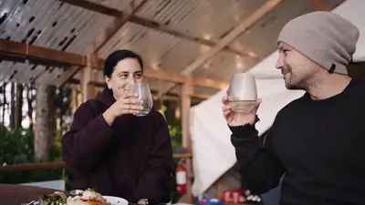 Guests raising a glass at dinner under the canopy