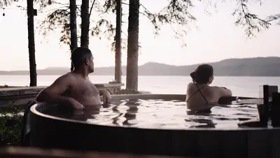 The wood-fired hot tub at sunset above the beach