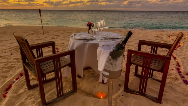 A table set for dinner on the sand at Long Bay