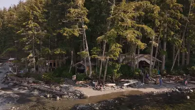 Orca Camp on its pebble beach, seen from the water